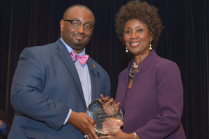 A.L. Fleming (left), vice president for development and alumni relations, presents a special token of appreciation to assistant professor Flo Hill for dedication 40 years of service to Albany State.