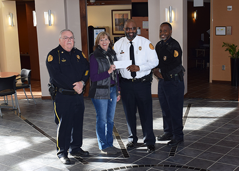 Albany State University Police Officers present Diane Rogers (center), executive director of Liberty House of Albany, with a check for $563 to support victims and survivors of domestic violence. L to r: Maj. James Brackin, Rogers, Lt. Brian Covington, and Sgt. Allen Jackson.                                      