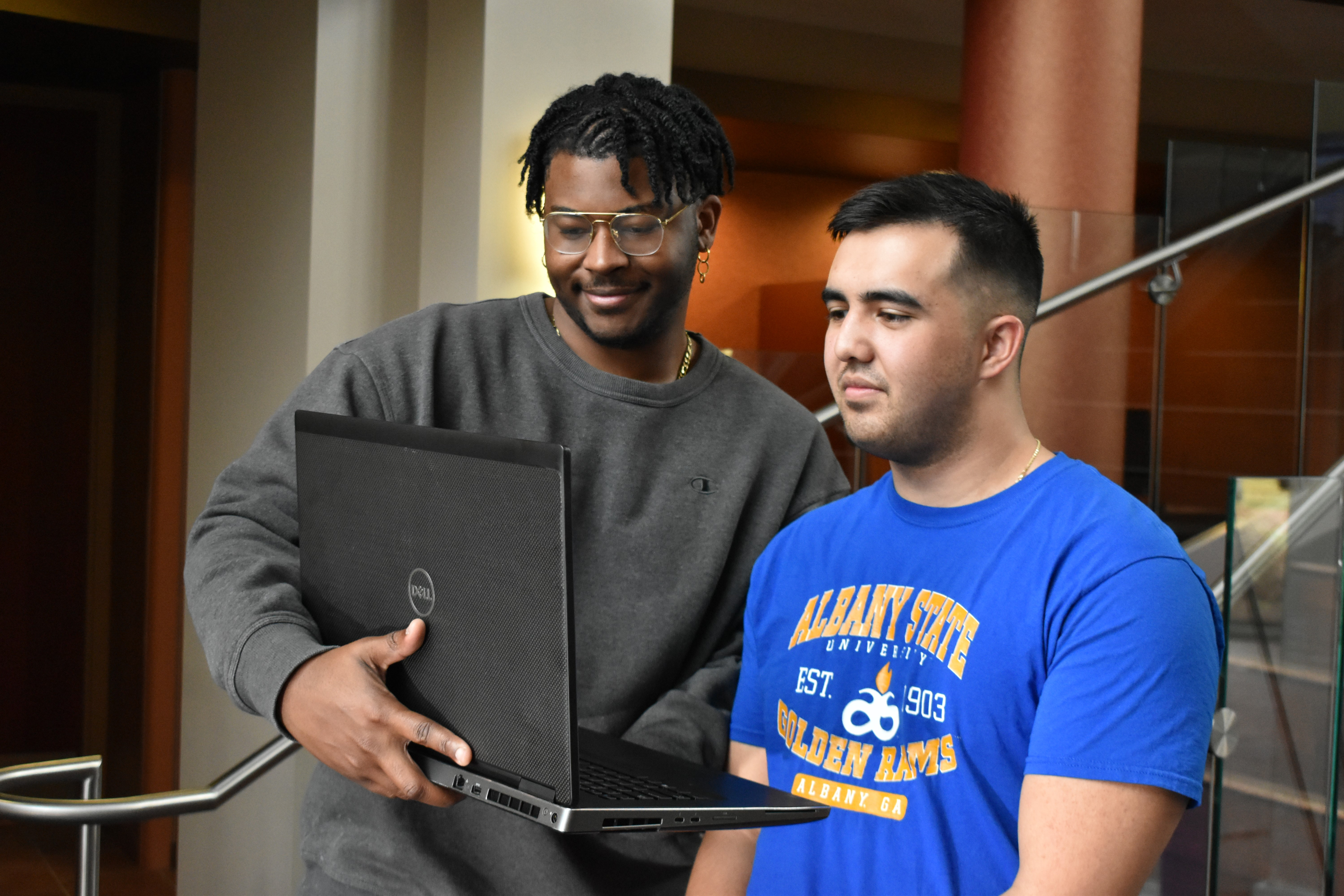 two male students looking at laptop