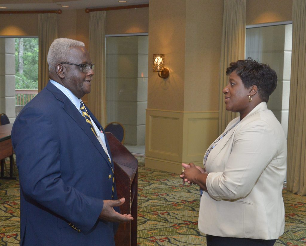 President Marion Fedrick (right) discusses university goals and accomplishments with ASU alumnus John Culbreath during the annual Alumni Planing Conference